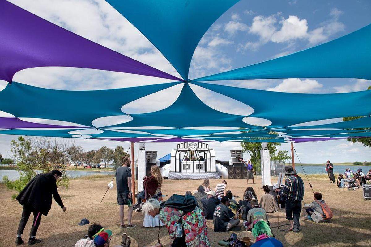 Attendees listen to the music of Entoptic during the Serenity Gathering at Woodward Reservoir in Oakdale, Calif., Saturday, April 28, 2018. 