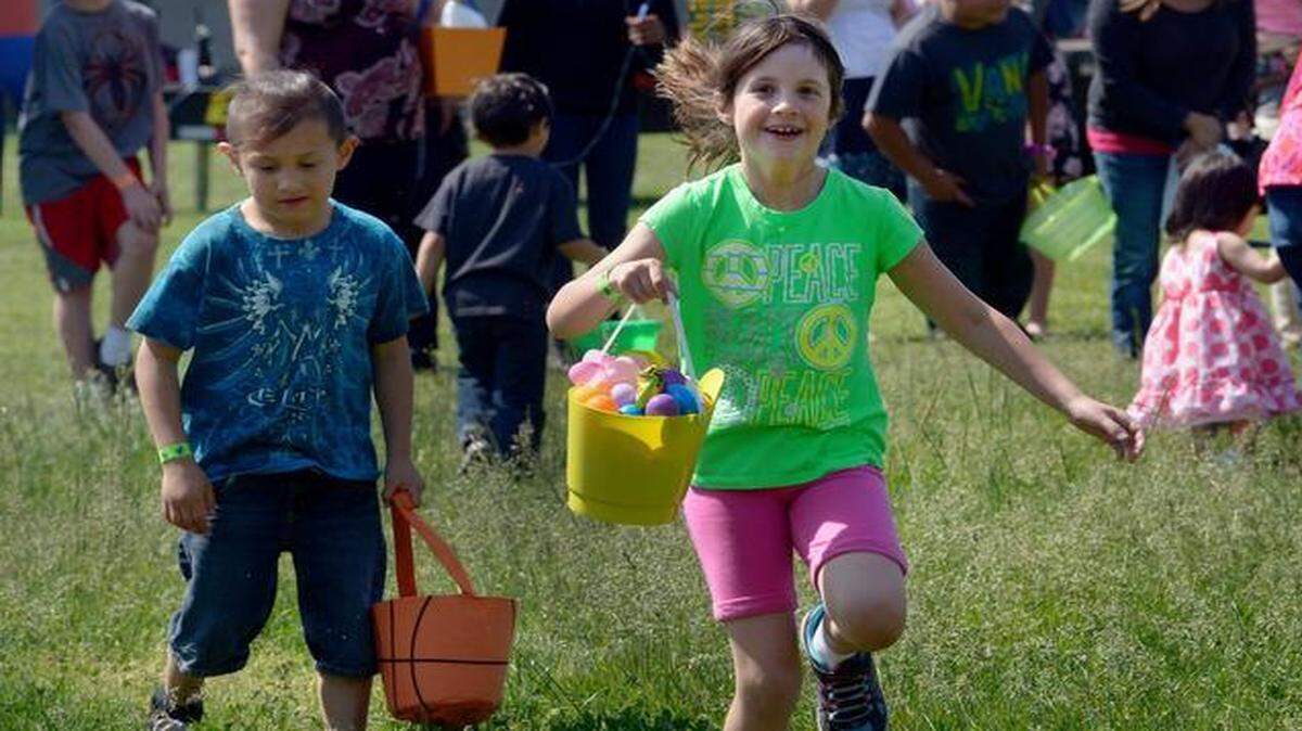 
Children run through the tall grass at the 2014 Easter Kidz Blitz. This year’s free hunt for more than 9,000 eggs starts at 10 a.m. Saturday at Neighborhood Church in Modesto. Below, a bunny basket is filled with eggs during 2014 Easter egg hunt in Modesto.
