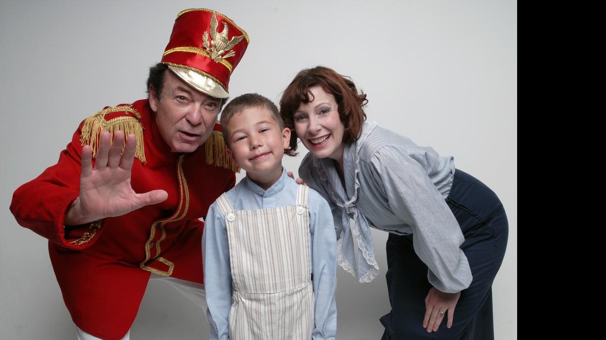 
 Chuck Gillespie, left, Aiden Arrieta, 8, and Alison Collins prepare for the Modesto Performing Arts production of “The Music Man.”
