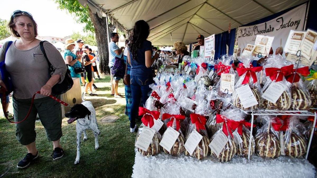 Candy-covered apples from DeBrito’s Chocolate Factory entice visitors at the 2015 Oakdale Chocolate Festival.