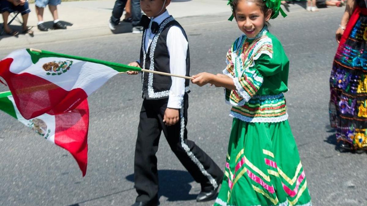 Adilene Megei waves a Mexican flag during the Cinco De Mayo parade in 2015. This year’s parade is Saturday, May 7, 2016.