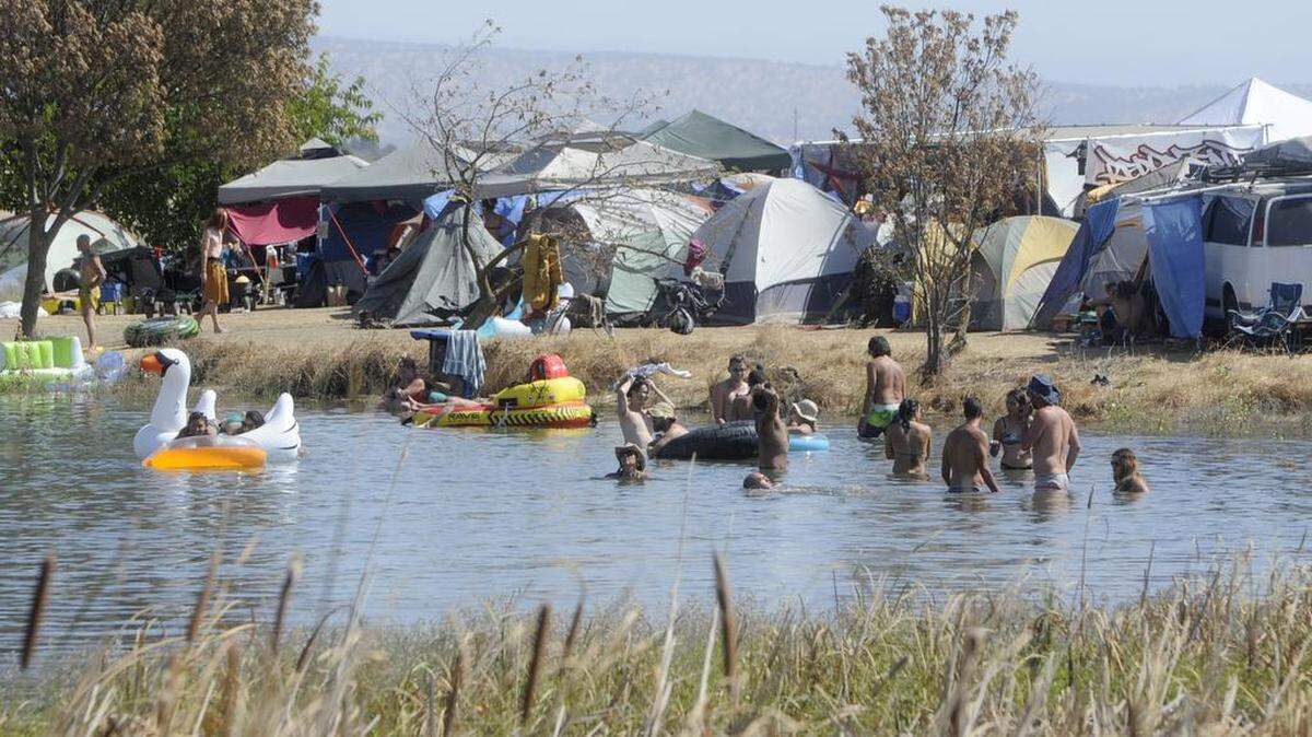 Festival campers relax in the water during the final day of the Symbiosis Gathering at Woodward Lake reservoir in Oakdale California on September 20, 2015.