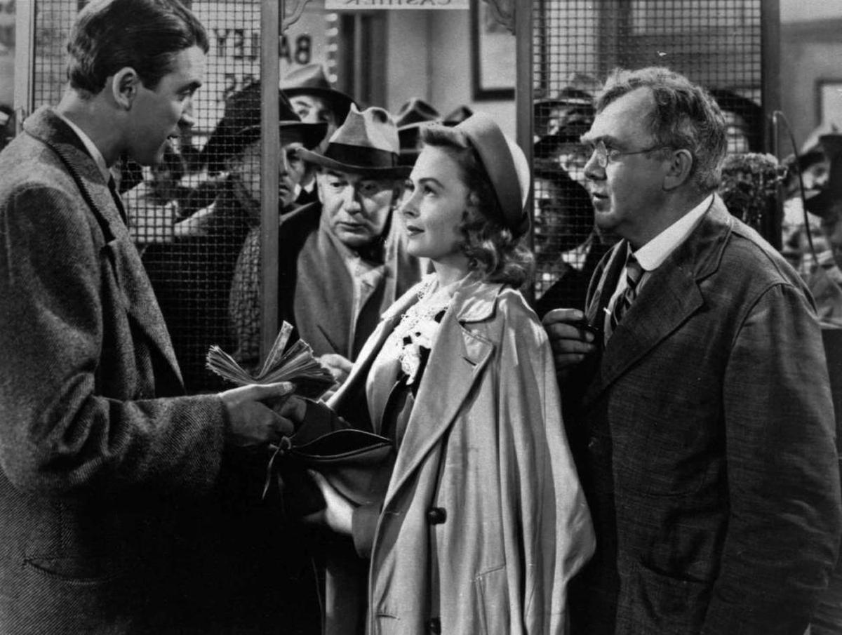 James Stewart, left, Thomas Mitchell, right, and Donna Reed appear in a scene from the 1946 film "It's A Wonderful Life."