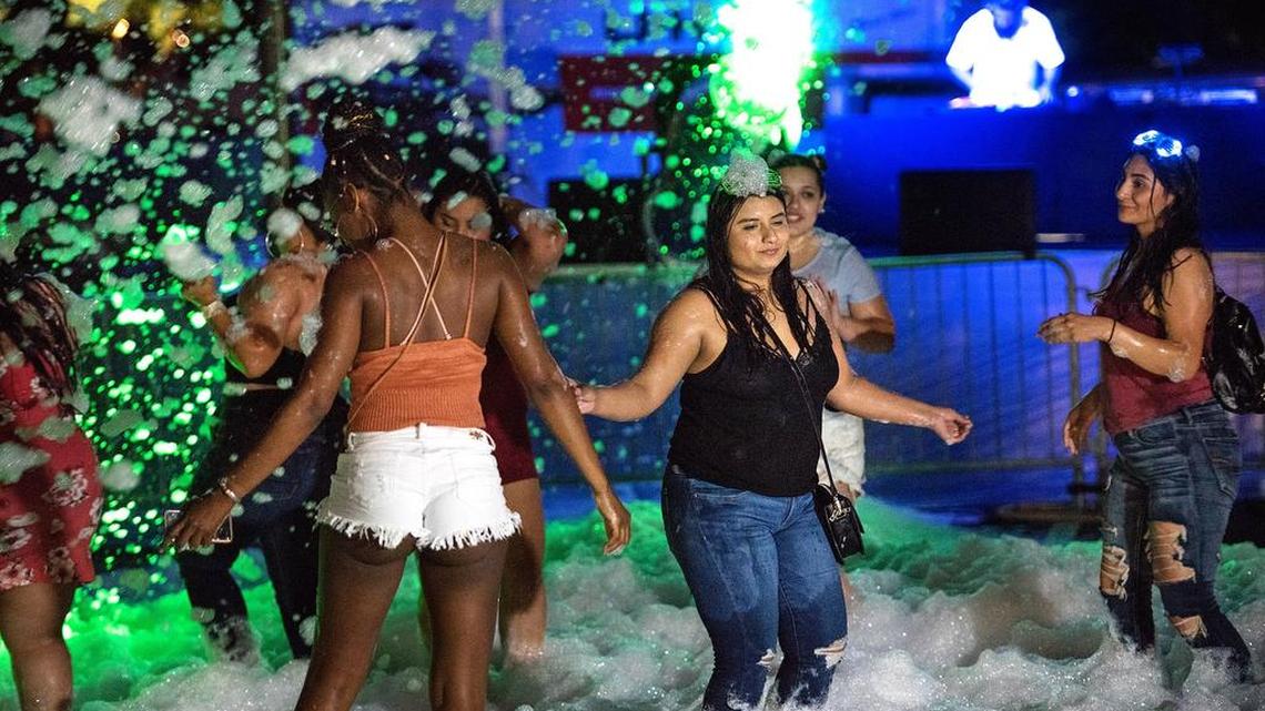 Party goers dance to electronic music during Foam Fest at Modesto Centre Plaza in Modesto, Calif., Saturday, July 7, 2018.