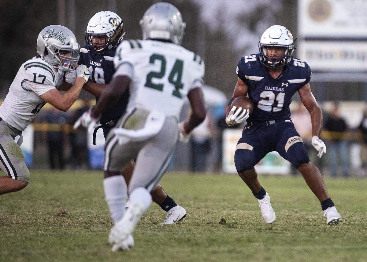 Central Catholic’s Minaya Olivo runs the ball during the non-league game with De La Salle at Central Catholic High School in Modesto, Calif., Aug. 30, 2019.