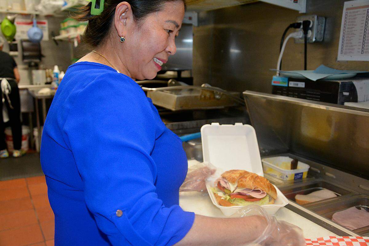 Sovanna’s Donuts owner and namesake Sovanna Lam fixes a sandwich in her Gustine, California, shop May 19, 2023.