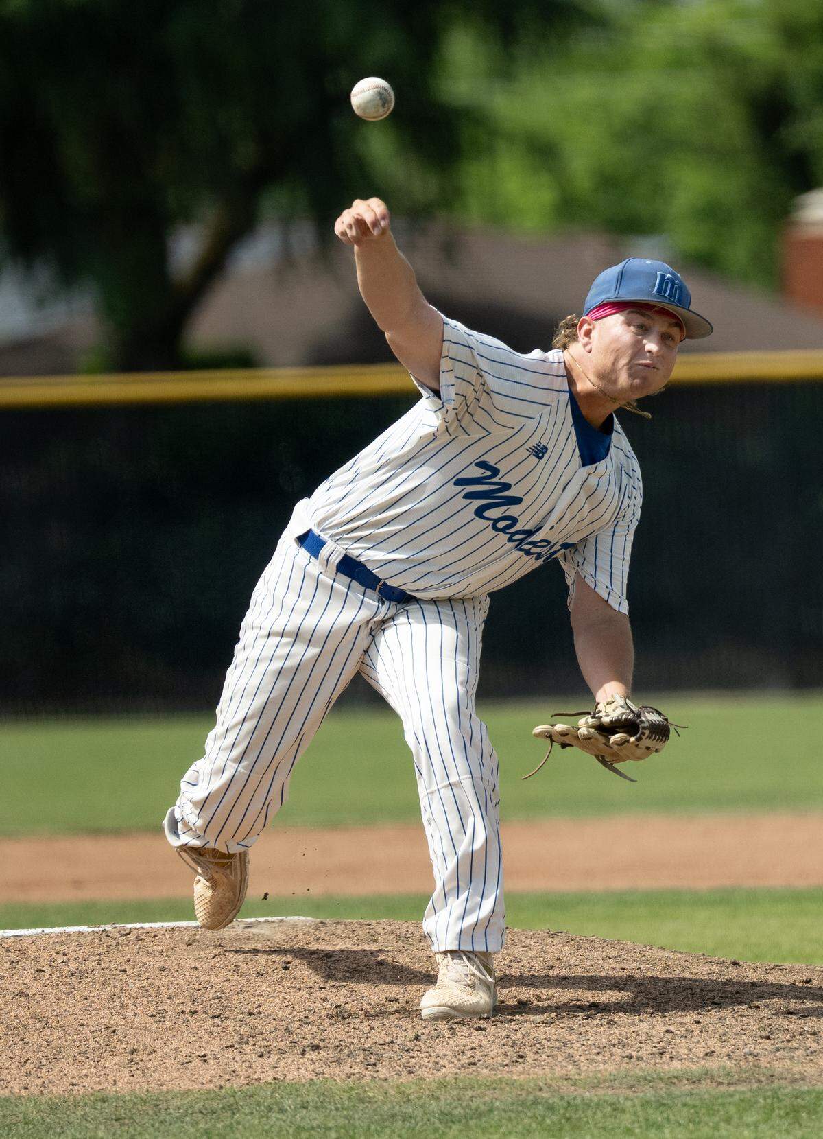 Modesto’s Kannon Sharpe delivers a pitch during the Northern California Regional playoff game with Reedley at Modesto Junior College on May 1, 2026. Modesto won the game 6-5.