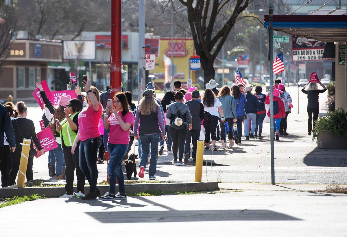 Marchers walk along McHenry Avenue during the Modesto Women’s March in Modesto, Calif., Saturday, Jan. 19, 2019.