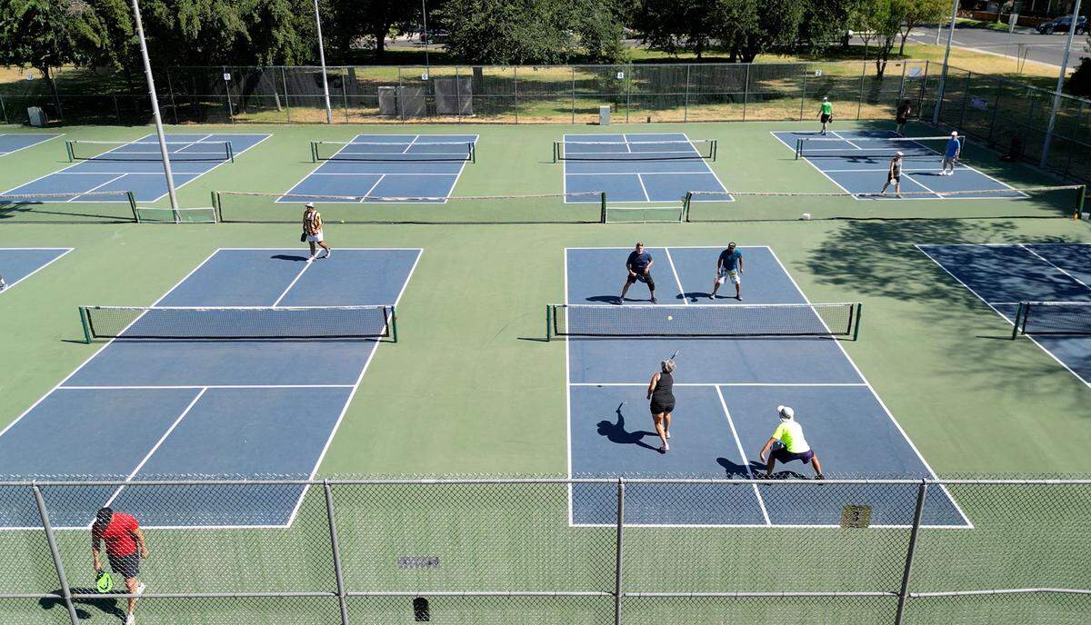 People play pickleball at Graceada Park in Modesto, Calif., Saturday, July 22, 2023.