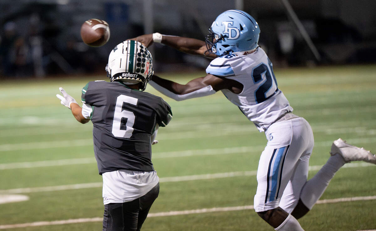 Downey’s Antwain Harper breaks up a pass to Pitman’s Santiago Flores.