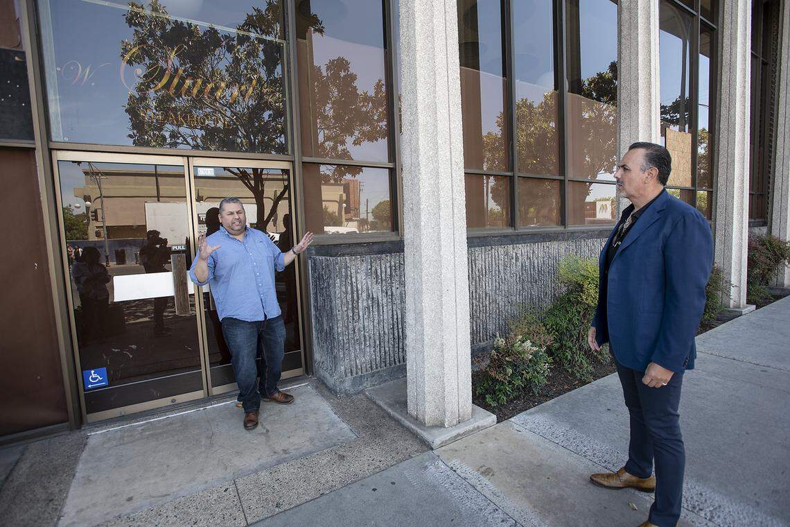 Owner Jaime Jimenez, right, and general manager James Madrid, left, look at the exterior of former World Savings Bank property at Tenth and I Streets in Modesto, Calif., Friday, May 3, 2019.