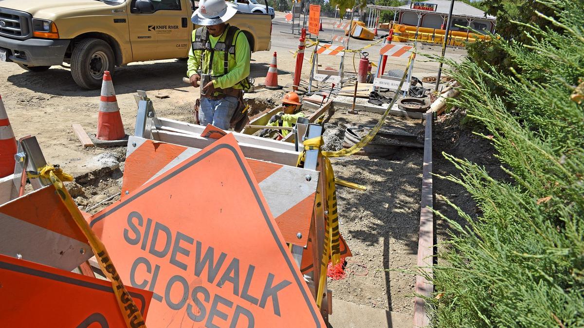 Alberto Molina with a construction crew with Knife River work on a sidewalk on Chicago avenue at Carpenter road in Modesto, Calif. on Thursday afternoon August 16, 2018. The Carpenter road  project is one of the road improvements in Modesto funded by sales tax revenue from voter-approved Measure L.