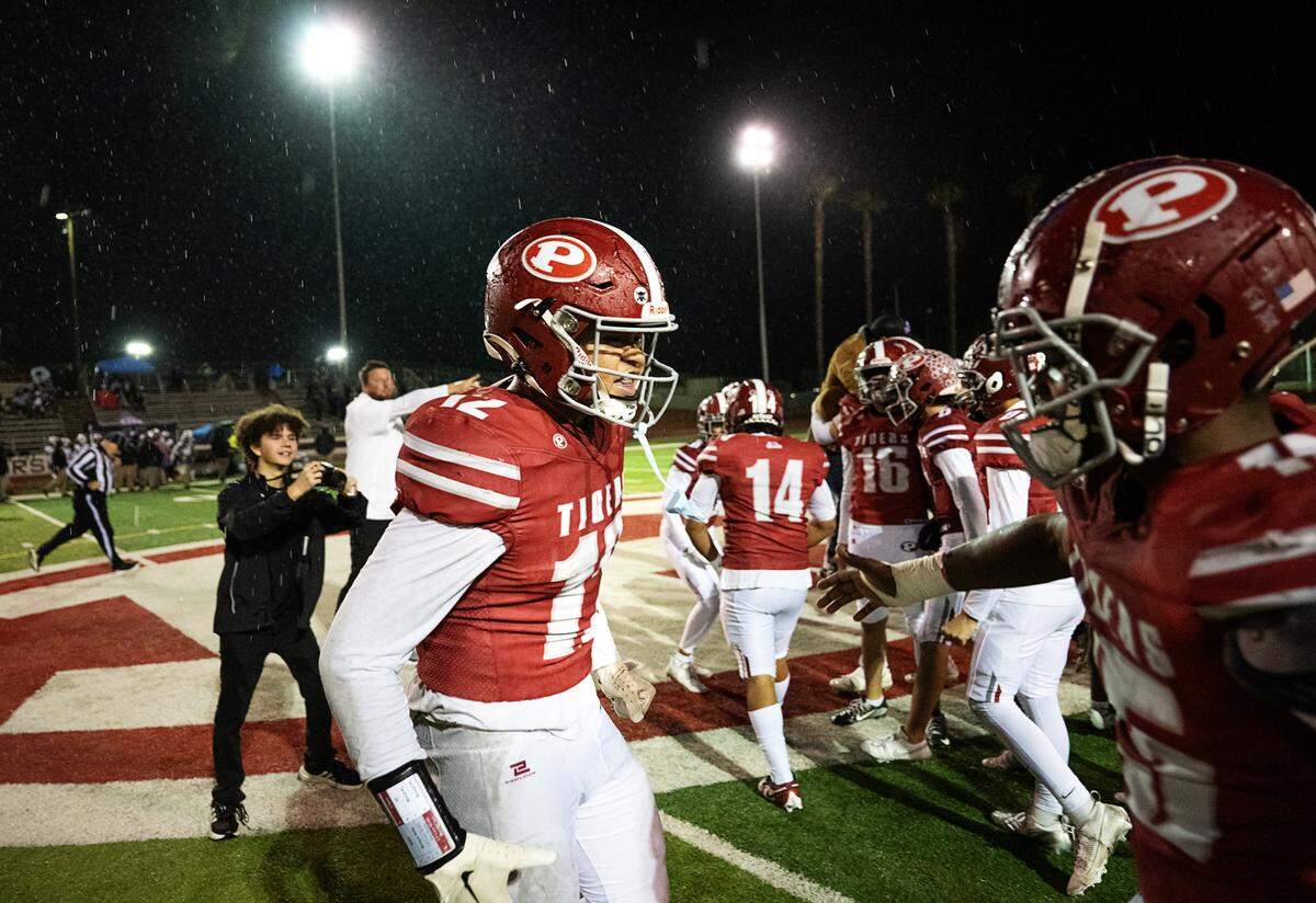 Patterson players Jace Johnson, left, and Dasen Pettis and teammates celebrate their 21-12 victory over Sacramento the Sac-Joaquin Section Division IV semifinal game at Patterson High School in Patterson, Friday, Nov. 22, 2024.
