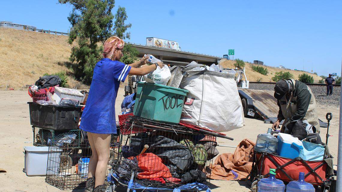 A couple, who declined to give their names for safety reasons, pack their belongings from the Turlock, Calif. homeless encampment they lived in on Wednesday, May 12, 2021. The city and CalTrans cleared the camp.