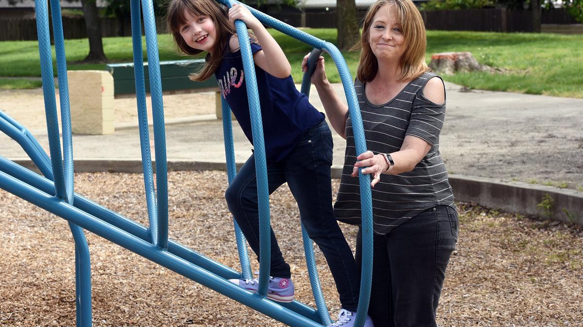 Mackenzie Whitlock, 9, of Modesto is pictured with her mother Jackie on Wednesday April 11, 2018 at Sylvan park in Modesto, Calif. Mackenzie had insulin-making islets moved from her pancreas to her liver in April of 2016.