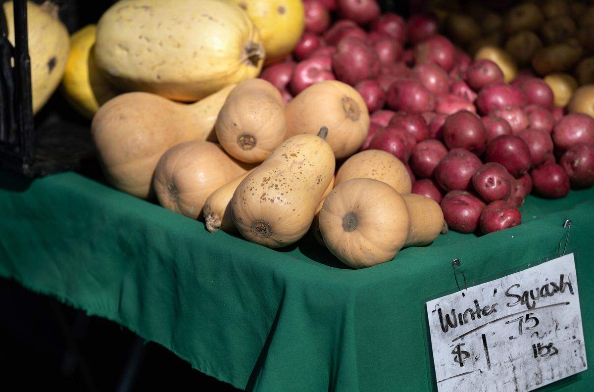 Winter squash spaghetti and butternut squash on a table next to potatoes at the Modesto Certified Farmers Market in Modesto, Calif., Saturday, Feb. 18, 2023.