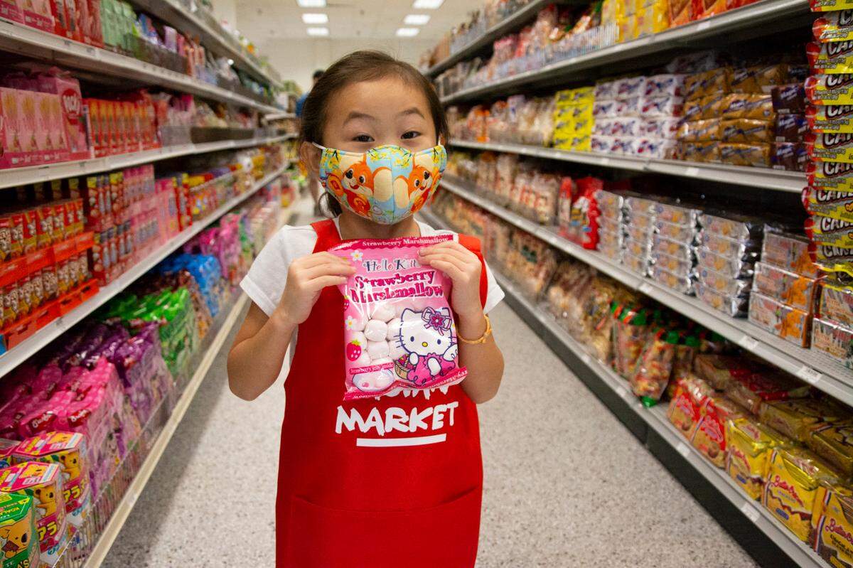 Stella Vuong, 5, shows off her favorite candy inside the Asian Market on McHenry Avenue in Modesto, Calif.