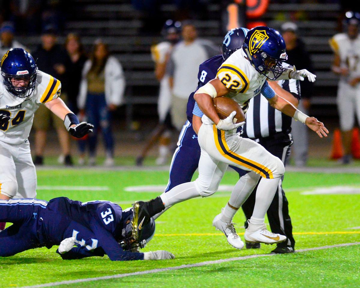 Turlock running back Josiah Gonzales (22) sprints away from Downey defenders during a game between Downey High School and Turlock High School at Downey High School in Modesto, CA on October 4, 2019.