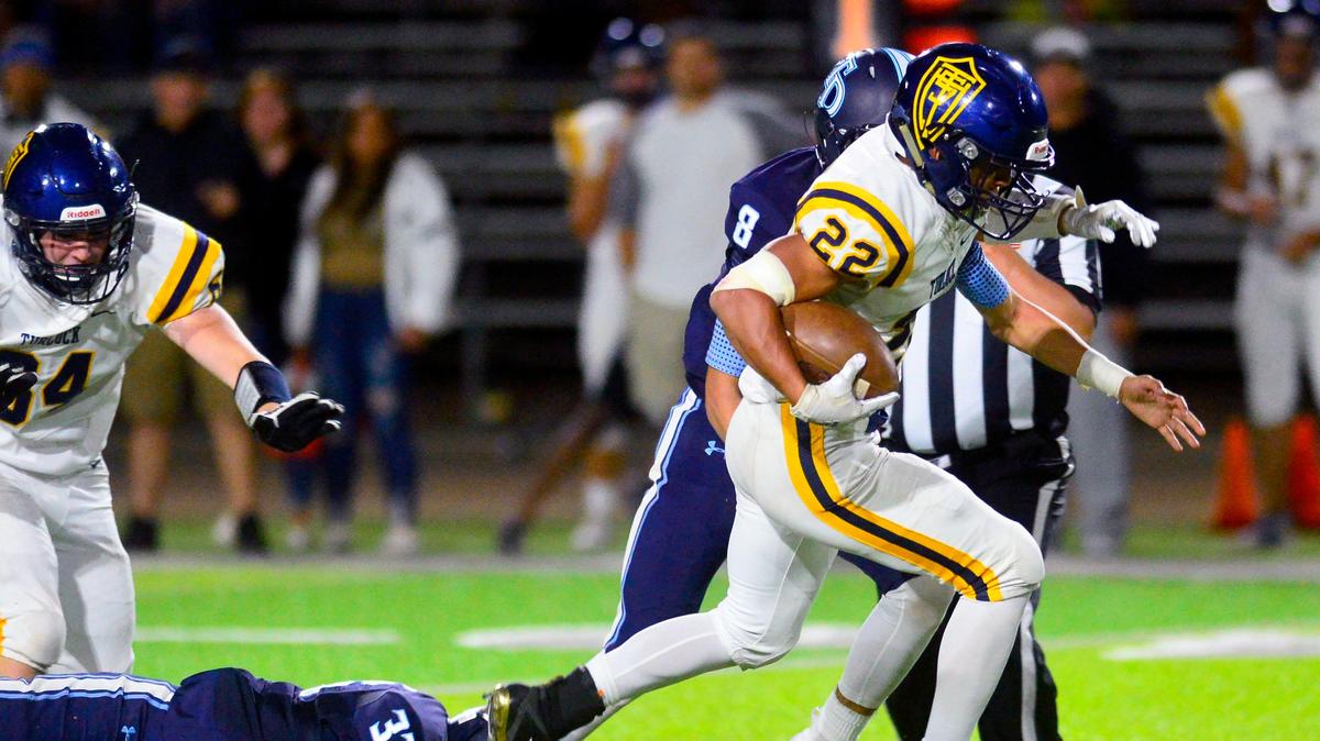 Turlock running back Josiah Gonzales (22) sprints away from Downey defenders during a game between Downey High School and Turlock High School at Downey High School in Modesto, CA on October 4, 2019.