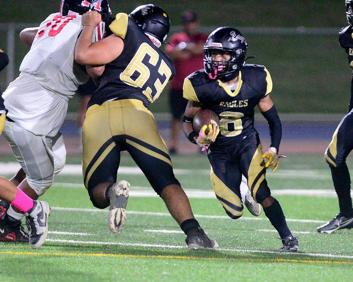 Enochs running back Eric Myles (8) runs around a block during a game between Modesto High School and Enochs High School at Gregori High School in Modesto, CA on October 4, 2024.