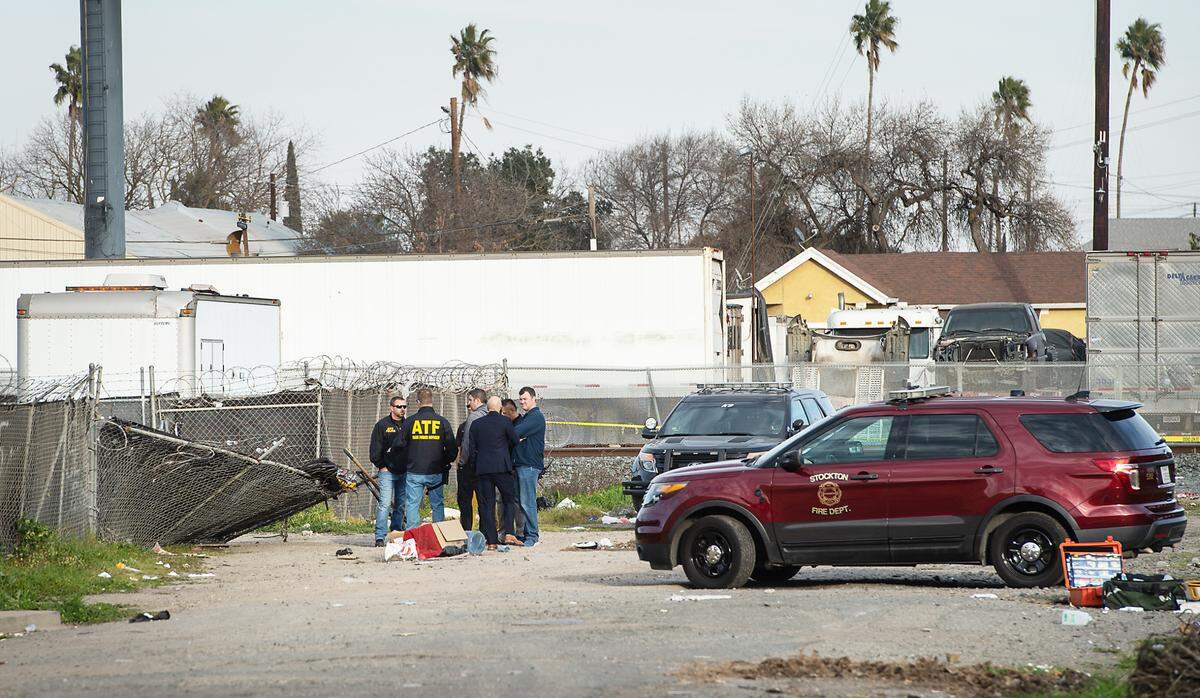 Law enforcement detectives investigate at the scene of a fatal shooting of Stockton Fire Captain Max Fortuna in Stockton, Calif., on Monday, Jan. 31, 2022.