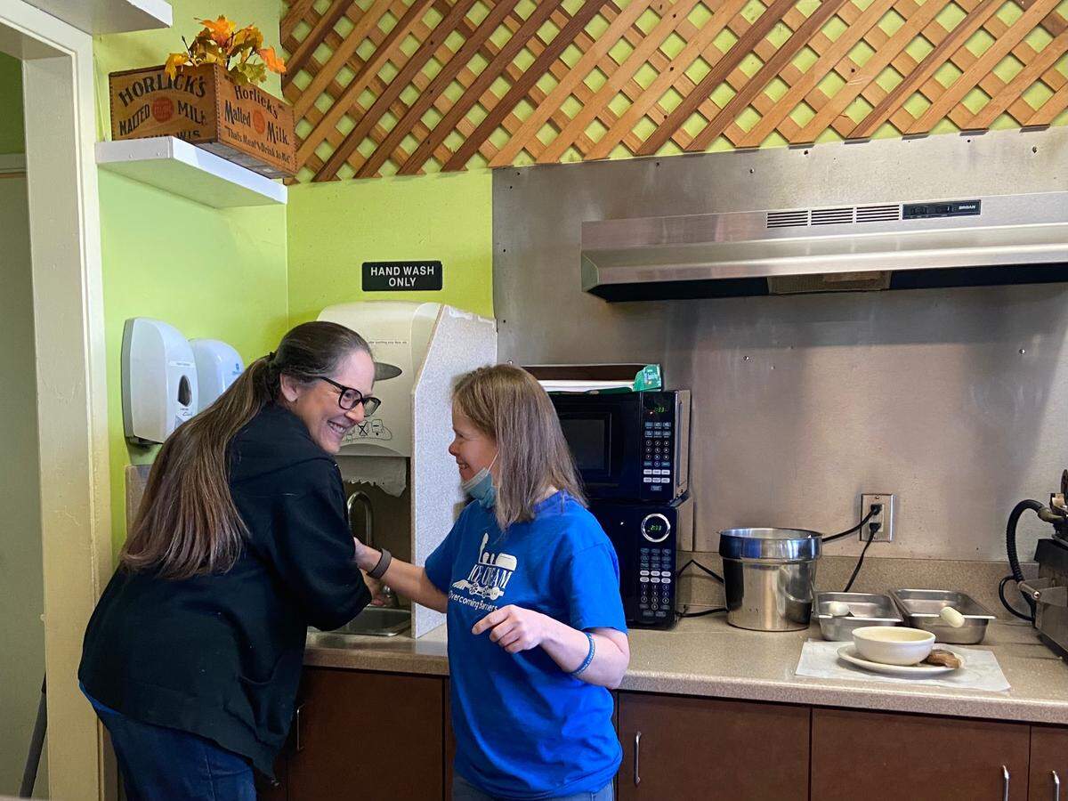 Ice Cream Company manager Kerri Gier laughs with Diane, the sister of executive director Bonnie Acree, while the two work on Dec. 21, 2021.