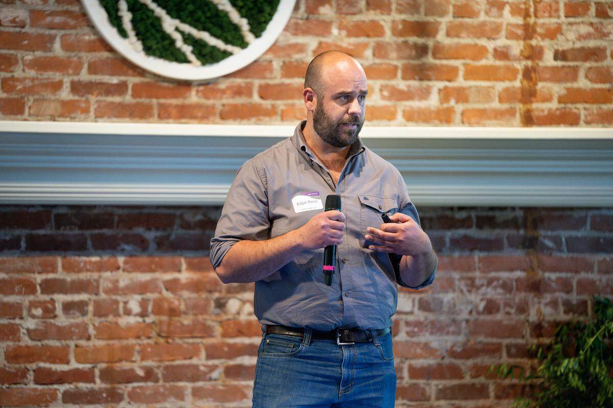 Edgar Perez from Turlock introduces his eco-friendly herbicide derived from almond hulls during the BEAM Circular Accelerator showcase at The River Mill near French Camp, Thursday, May 22, 2025.