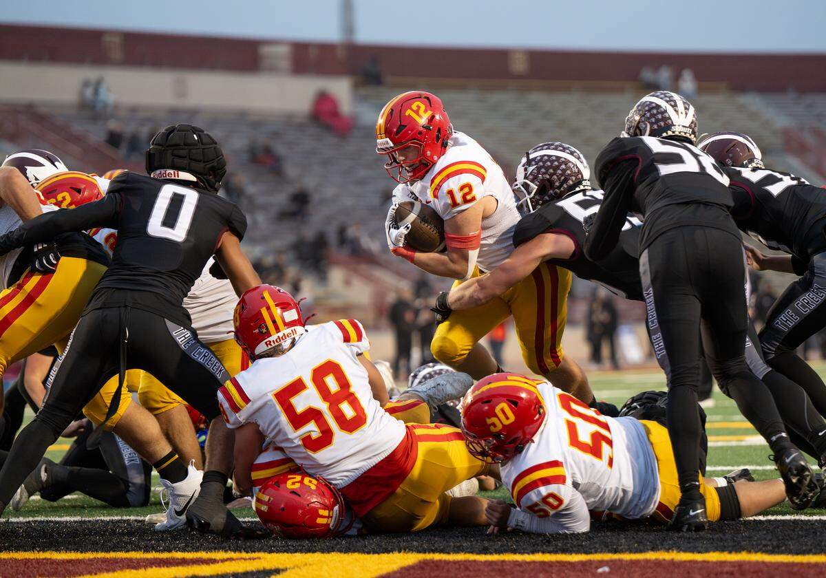 Oakdale’s Wes Burford runs the ball in for a touchdown during the Sac-Joaquin Section Division III championship football game with Woodcreek at Hughes Stadium in Sacramento on  Friday, Nov. 28, 2025.