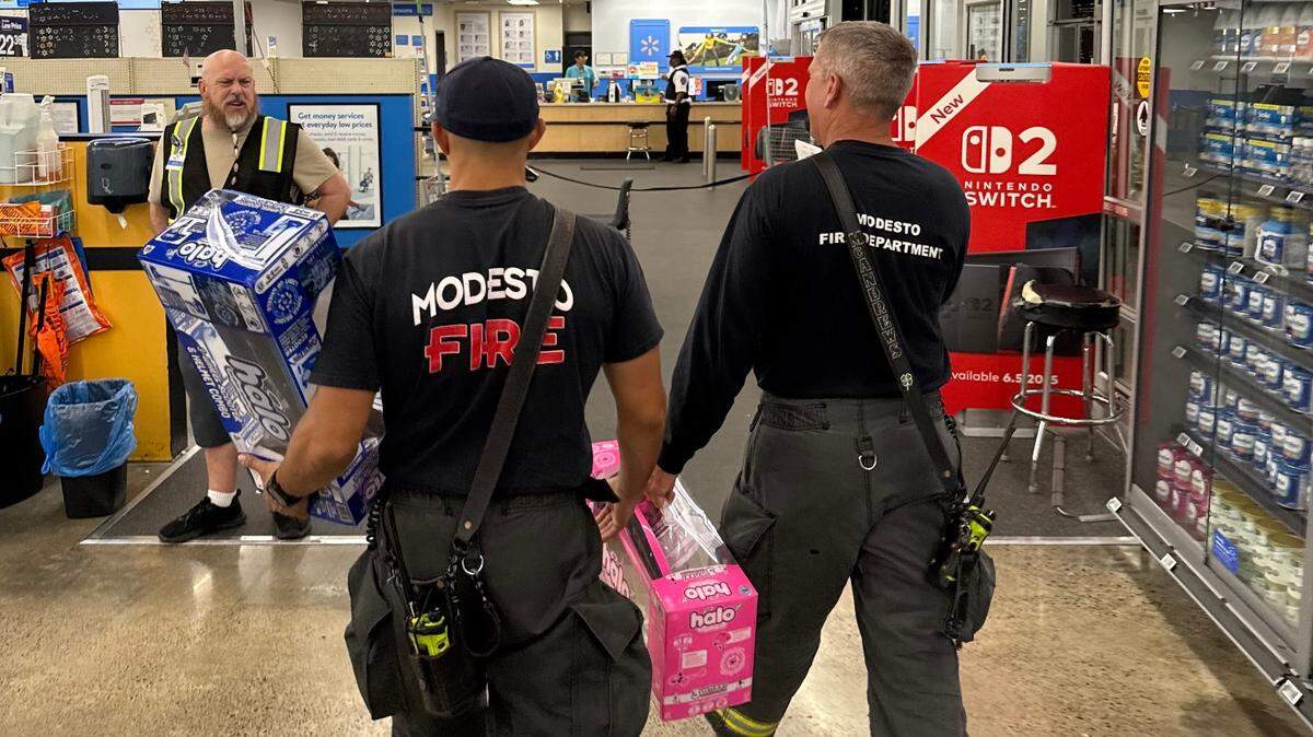 Modesto Firefighters shop for a replacement scooter and helmet after a child’s was destroyed in a motorcycle crash on Thursday, July 17, 2025.