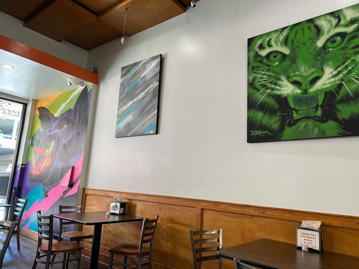 Wall art from local artist Fasm hangs at Food Fix Butcher and Baker.