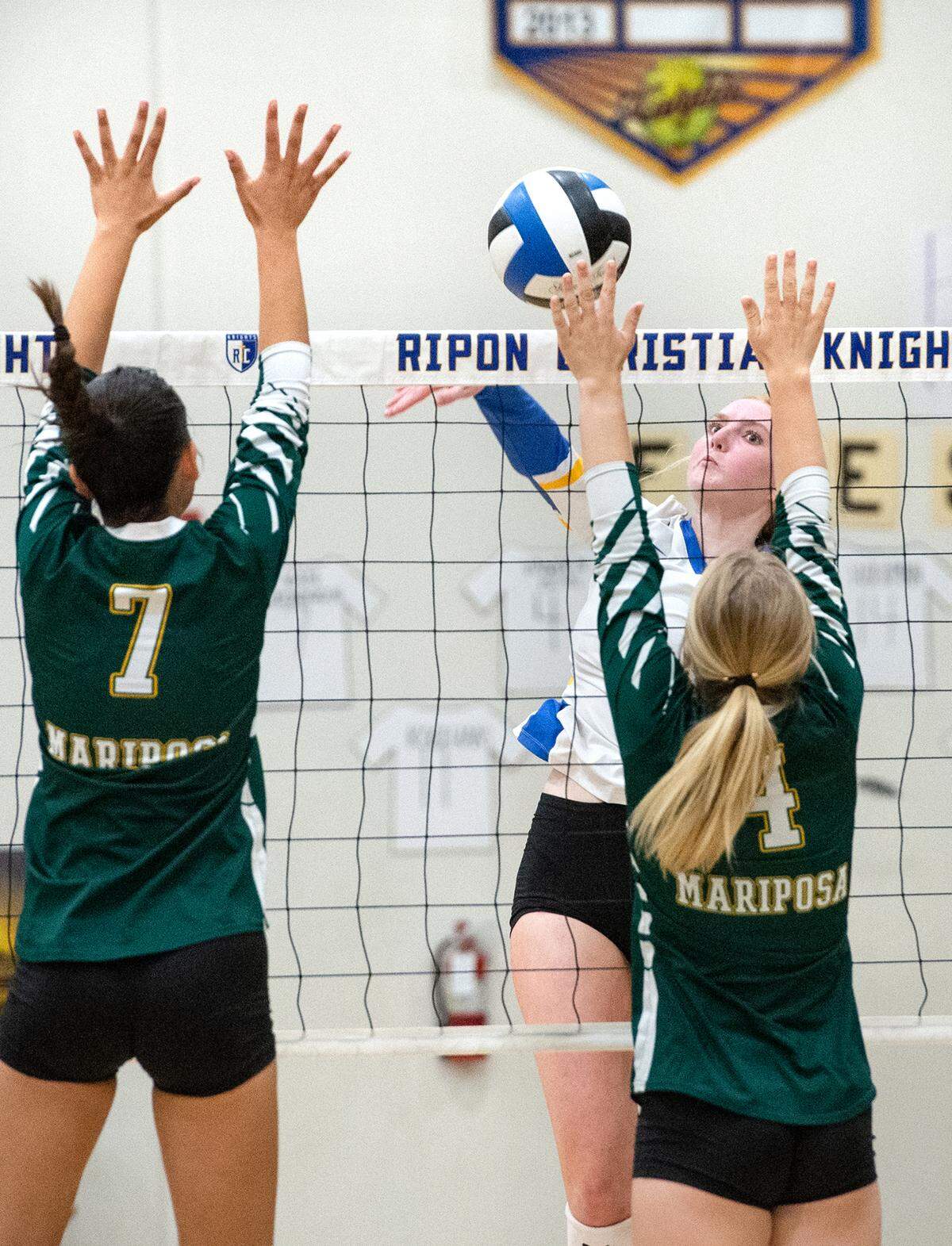 Ripon Christian’s Ava Van Groningen battles at the net with Mariposa’s Marion Sberna (7) and Bella Twiss (4) during the Southern League game in Ripon, Calif., Thursday, Oct. 13, 2022. Ripon Christian won the match 3-0.