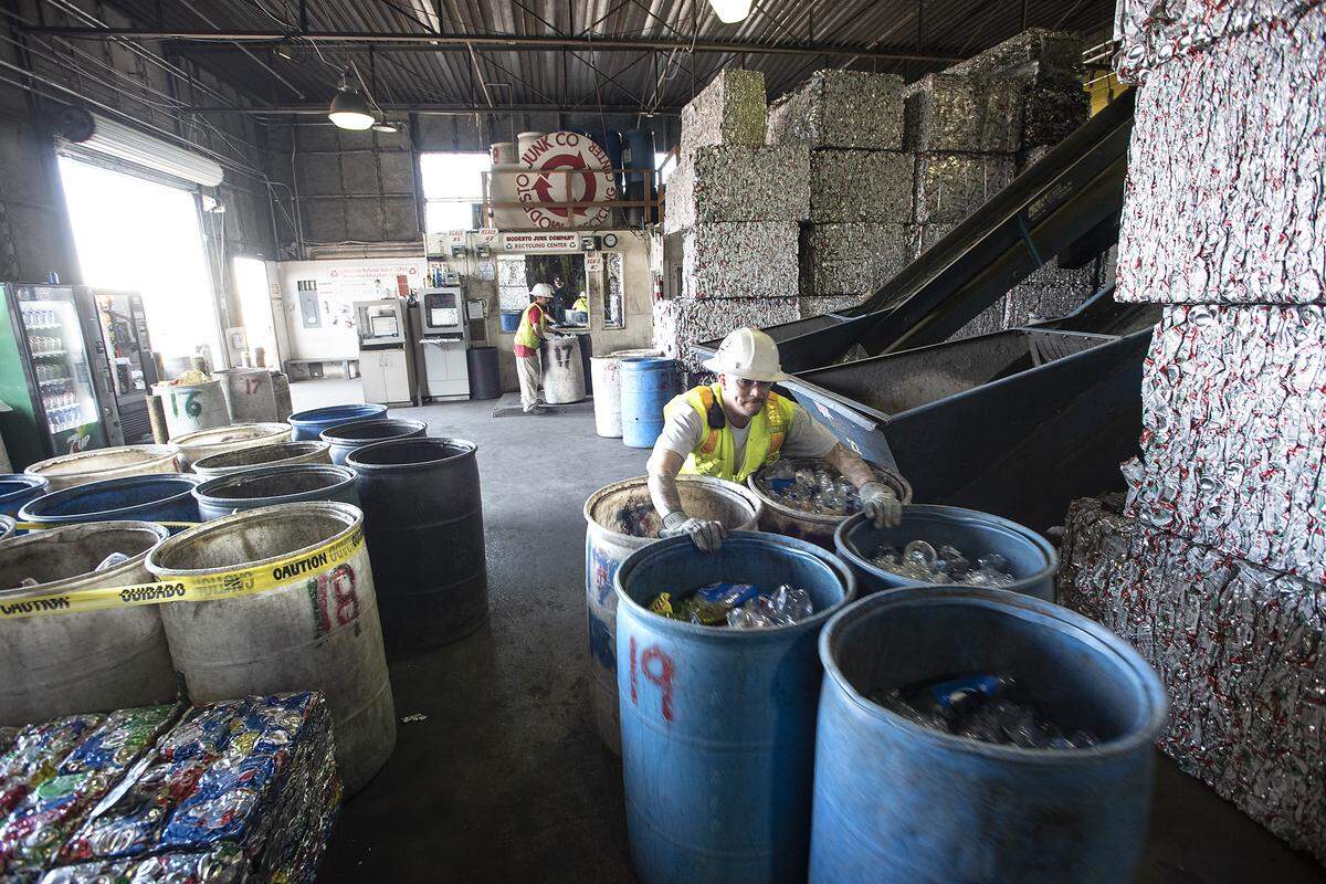 Recycling Center manager Chris Martinez sorts plastics and glass at Modesto Junk Co. in 2020.  