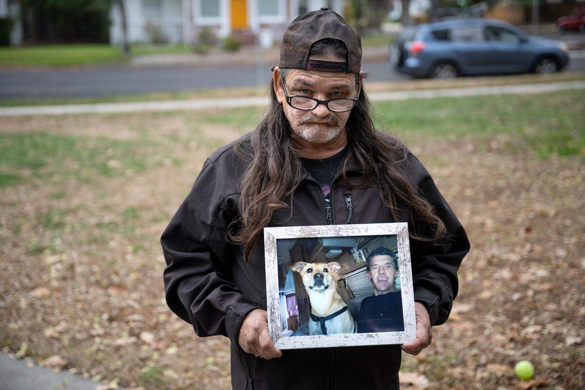 George Edgemon holds a picture of his friend Carl Wolden after a celebration-of-life picnic at Graceada Park in Modesto, Friday, Dec. 13, 2024. Wolden, who would often feed the homeless, died recently from an illness.