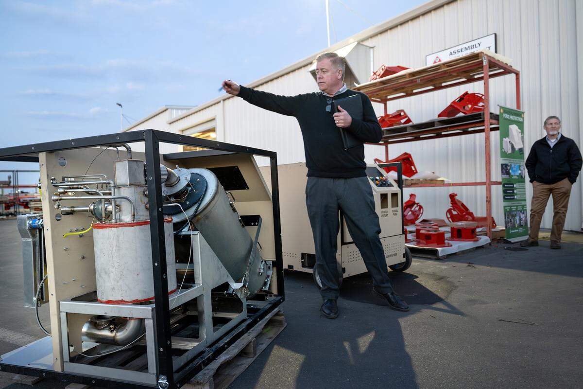 Caribou BioFuels CEO Kieran Mitchell describes the process of converting trash into fuel with his company’s machine that is being manufactured at Flory Industries in Salida.