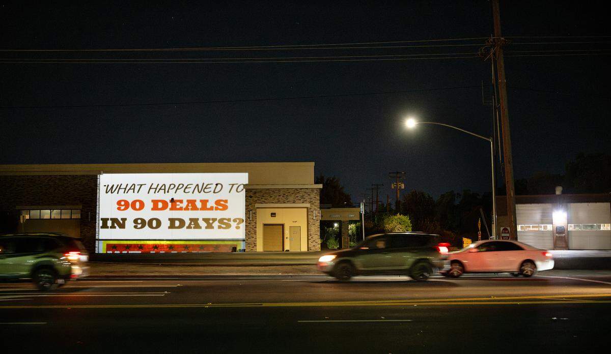 Local activists have started using a projector to display protest messages on buildings as a form of silent visual protest. Photographed on Briggsmore Avenue in Modesto, Thursday, July 24, 2025.