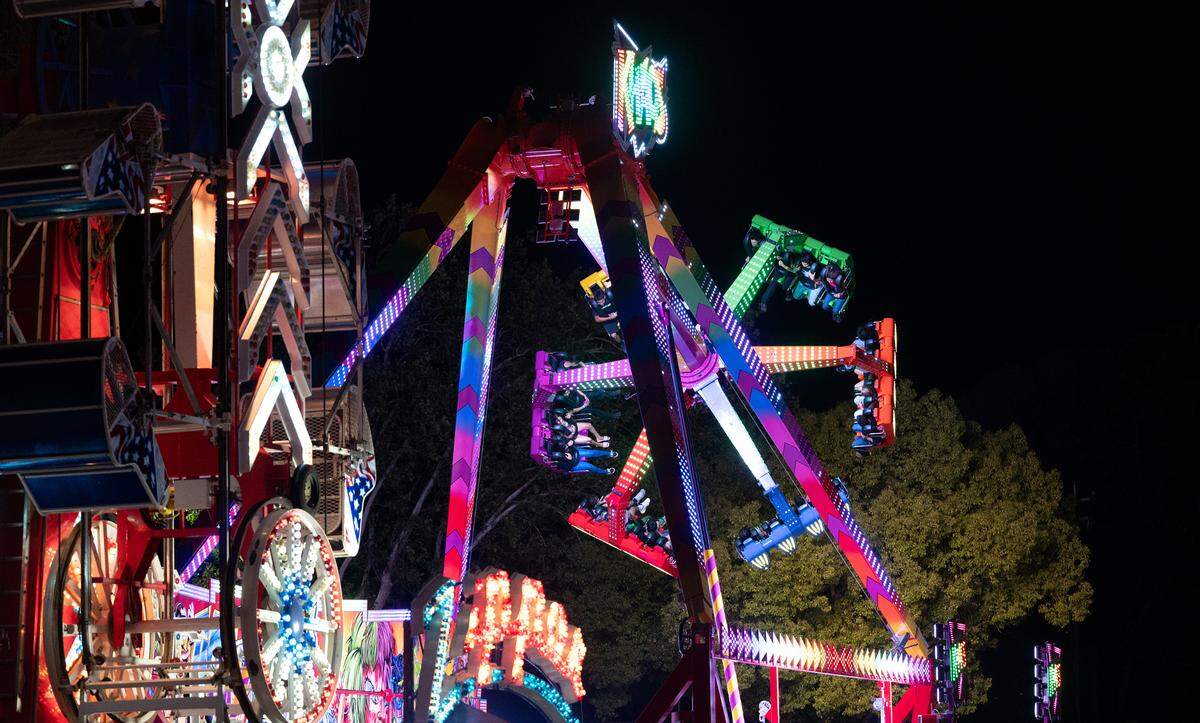 Fairgoers enjoy the rides in the midway during the Stanislaus County Fair in Turlock, Calif., Saturday, July 6, 2024.