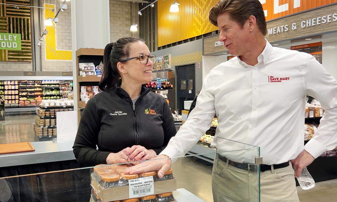 CEO Chris McGarry talks with cheese specialist Jamie Stock at Save Mart supermarket on Oakdale Road in Modesto, Calif., on Wednesday, April 6, 2022.