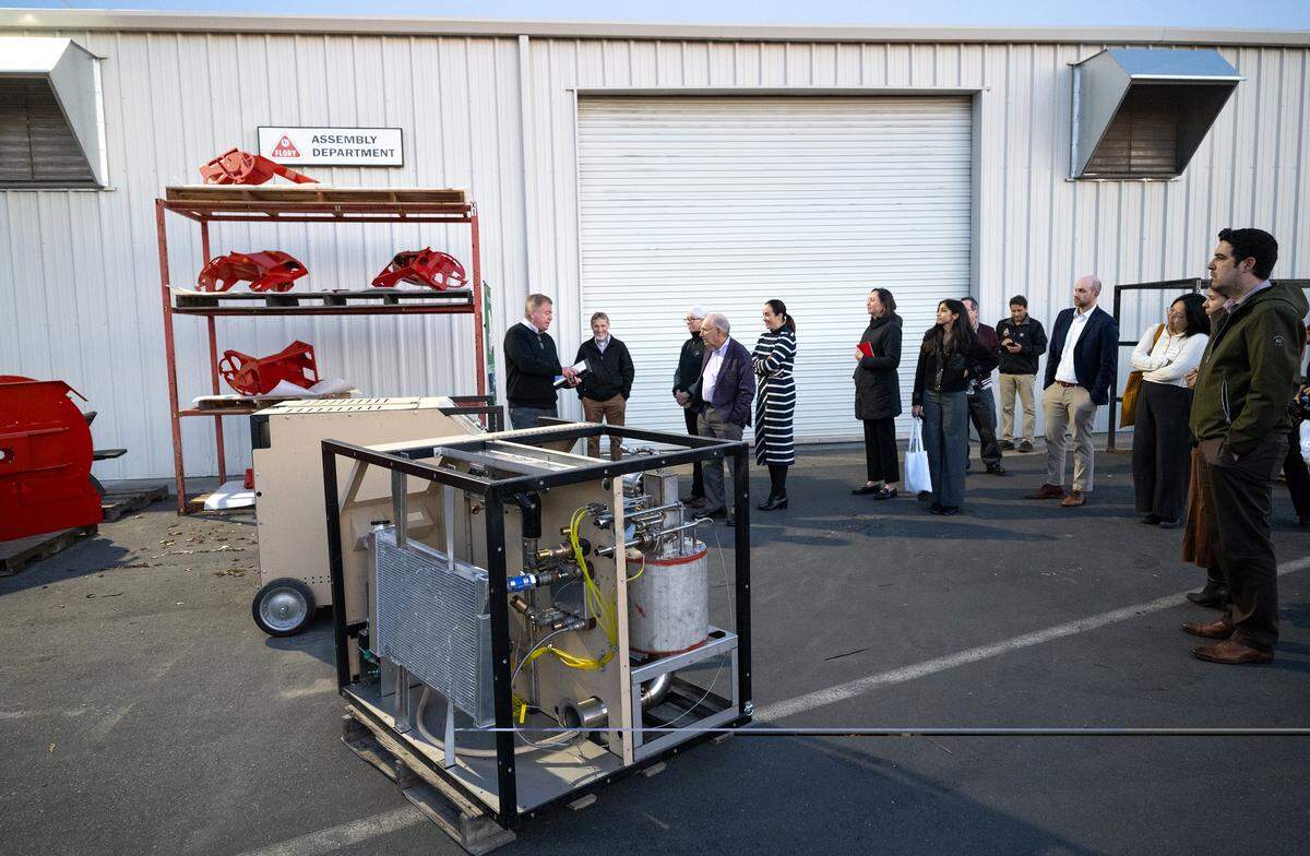 Caribou Biofuels CEO Kieran Mitchell gives a tour of his new machines for a few members of the National Security Commission on Emerging Biotechnology at Flory Industries in Salida.