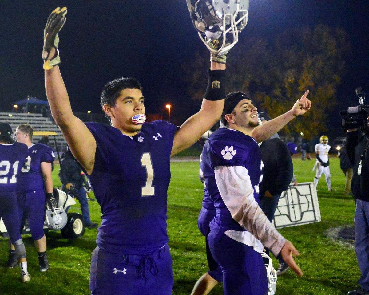 Denair players Will Knox (1) and Drew Pritchard (2) celebrate winning the the CIF Division 7-AA championship game between Denair and Santee at Denair High School in Denair California on December 1, 2018.