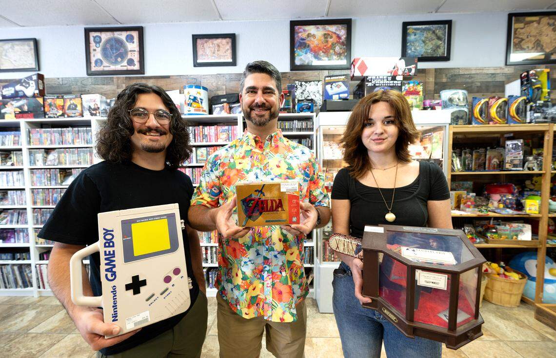 Laughing Crow Collectibles owner Jerod Pimentel, middle, and his children Jace, left, and Jiana, right, in Modesto, Calif., Thursday, May 2, 2024.