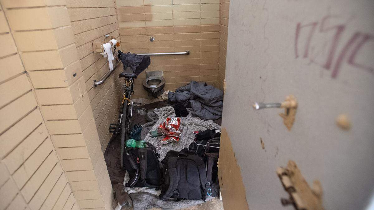 Two homeless people camped overnight in the restroom at Davis Park in Modesto Calif., on Wednesday, Nov. 3, 2021.