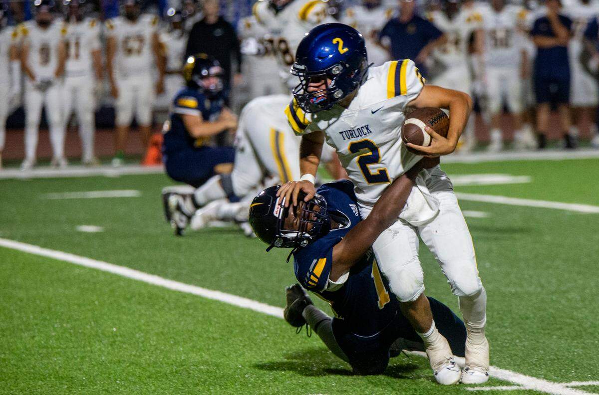 Vincent Gonzales, 2, of Turlock High gets taken down by a Gregori defender Thursday Sept. 28, 2023 night.