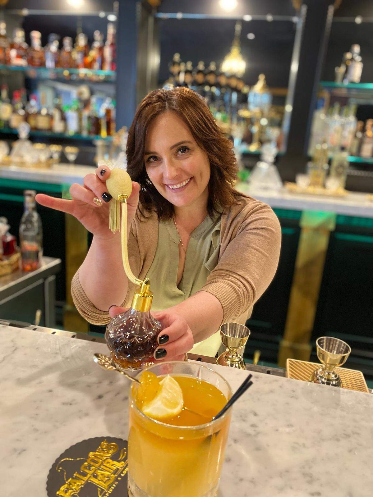 Owner Moe Willey shows off a craft cocktail at the bar of the new Falcon’s Lair restaurant and lounge opening in Ripon in March 2023.