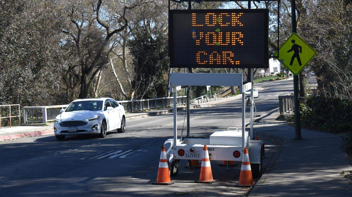 An alternating message board on La Loma Avenue in Modesto reminds drivers to lock their vehicles. It also reads, “Remove all valuables.”