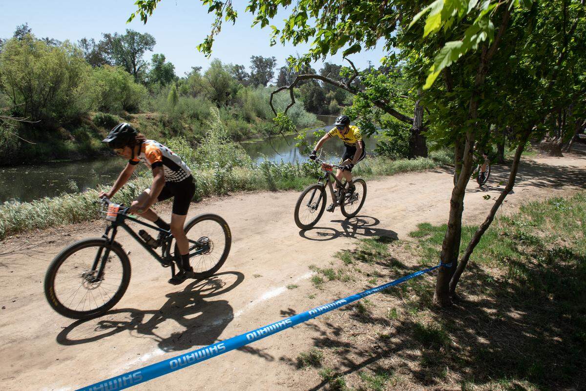 Riders follow the course in the boys junior varsity division II race during the NorCal Interscholastic Cycling League event at the Tuolumne River Regional Park in Modesto, Calif., on Saturday, April 9, 2022.