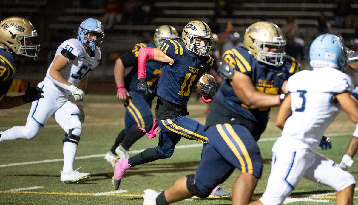 Turlock’s Landyn Fitzgerald (11) runs the ball during the Central California Athletic League game with Downey at Turlock High School in Turlock, Friday, Oct. 18, 2024.