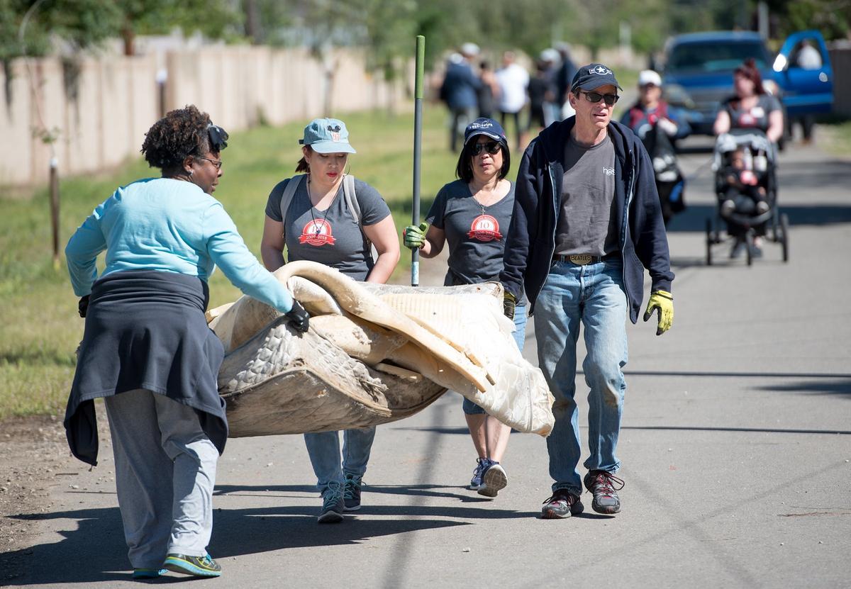 From the left, Laura Hatten, Jana Medek, Cheryl Medek, and Dean Medek remove garbage from the Helen White Memorial Trail during Love Modesto, a community-wide volunteer day, in Modesto, Calif., on Saturday, April 21, 2018.
