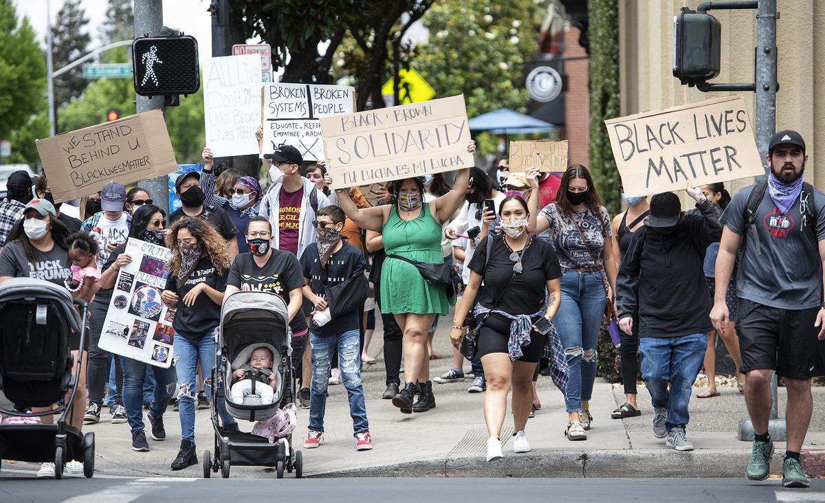 Demonstrators joined people around the country in demonstrating against the death of George Floyd by marching in downtown Modesto, Calif., on Saturday, May 30, 2020.