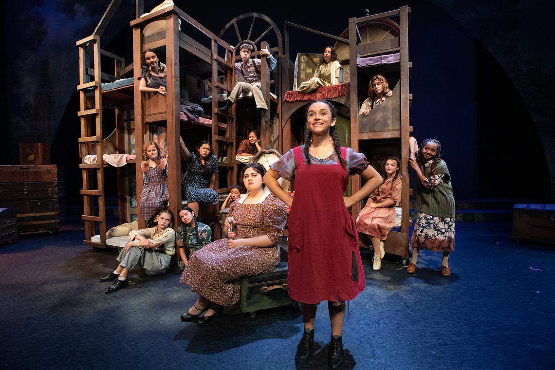 Alexia Cuevas, front, is Annie and Zuhey Perez, front left, is Miss Hannigan in the YES Company production of “Annie” at the Gallo Center for the Arts in Modesto, Calif., on Friday, July 8, 2022.