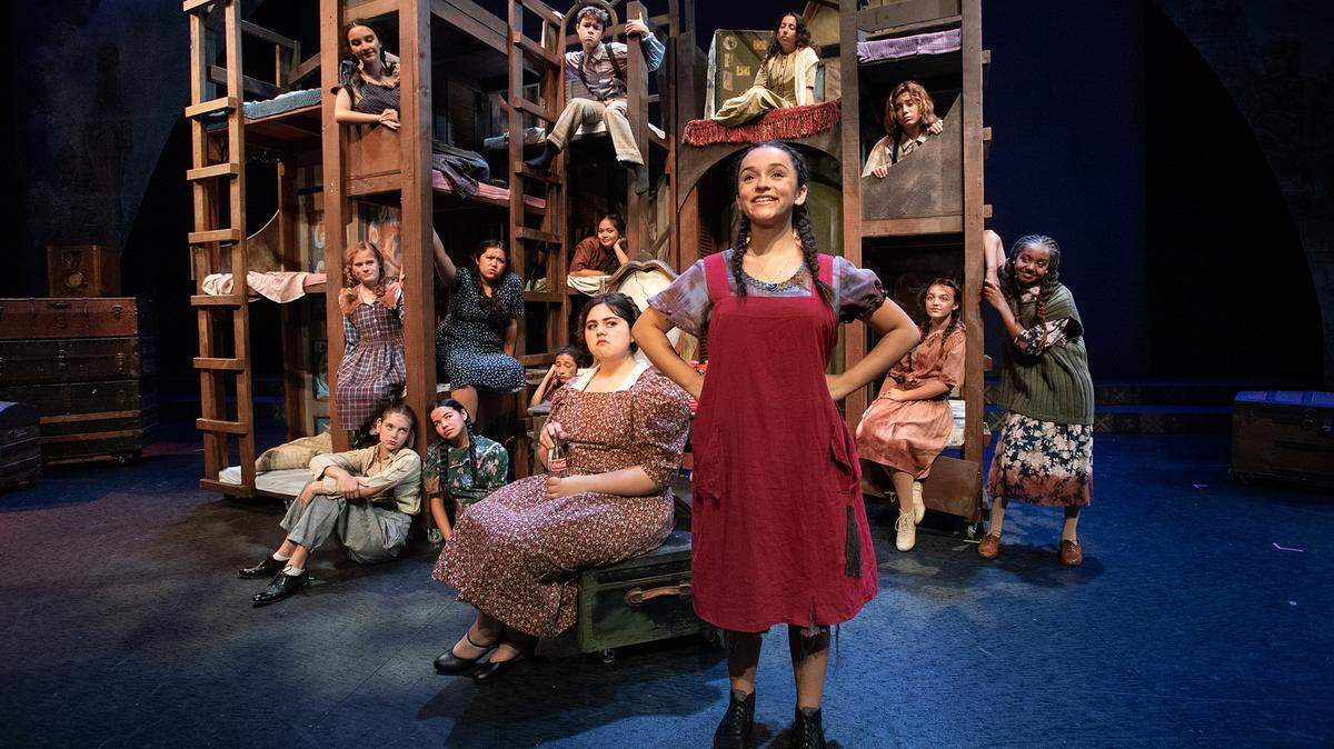 Alexia Cuevas, front, is Annie and Zuhey Perez, front left, is Miss Hannigan in the YES Company production of “Annie” at the Gallo Center for the Arts in Modesto, Calif., on Friday, July 8, 2022.